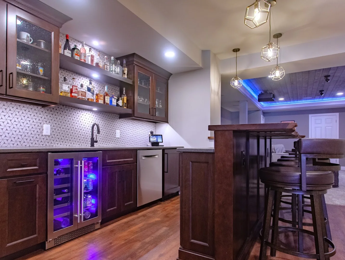 Residential bar designed with integrated cabinetry and lighting